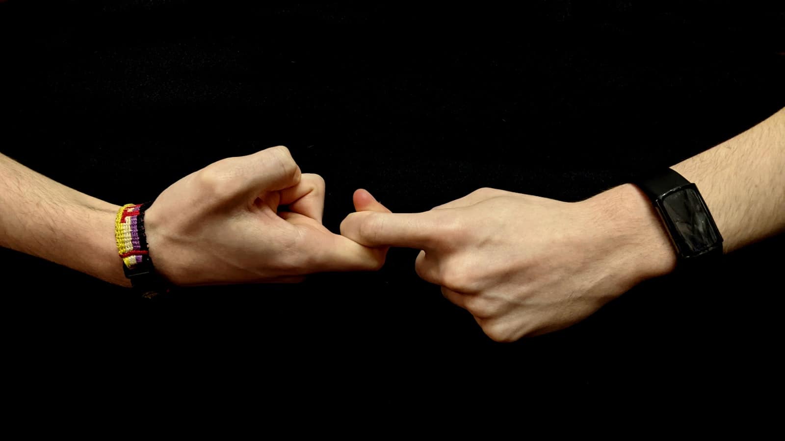 Two hands forming a sign in American Sign Language
